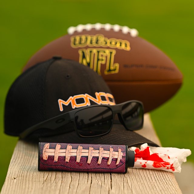 Monocz pocket monocular resting on a ballcap brim